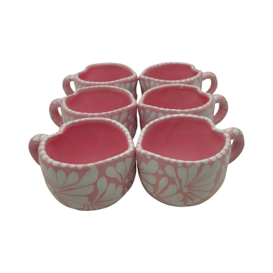 The Talavera Hub set of six heart-shaped pink ceramic mugs with hand-painted white floral Talavera patterns