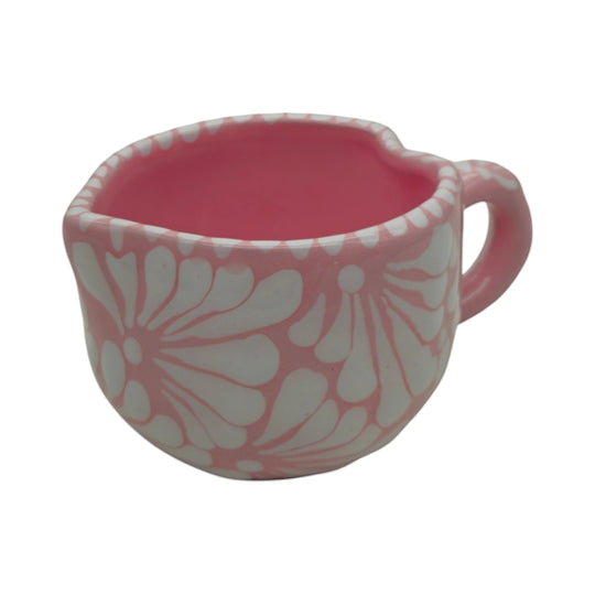 The Talavera Hub hand-painted pink and white ceramic heart-shaped mug with floral patterns.