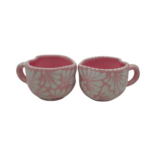 Two The Talavera Hub heart-shaped ceramic mugs with hand-painted pink and white floral patterns on a white background.