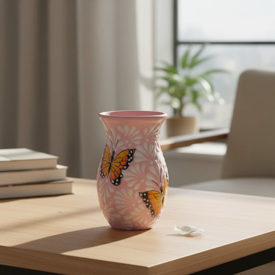 The Talavera Hub pink and white ceramic vase with monarch butterfly motif, handcrafted in Mexico.