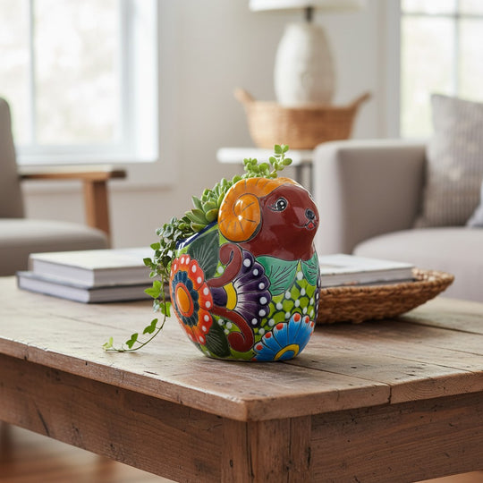 The Talavera Hub colorful ceramic ram planter with hand-painted floral patterns and succulents.