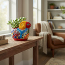 The Talavera Hub colorful ceramic ram planter with hand-painted floral details and succulents.