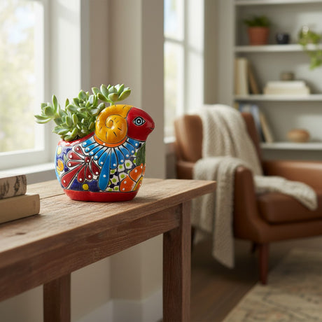The Talavera Hub colorful ceramic ram planter with hand-painted floral details and succulents.