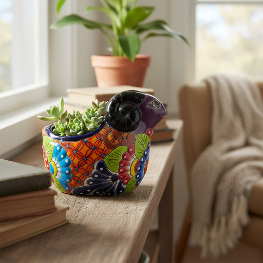 The Talavera Hub colorful ceramic ram planter with hand-painted floral designs and succulents.
