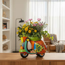 The Talavera Hub large ceramic scooter planter, hand-painted with vibrant floral designs in orange, green, blue, and yellow.