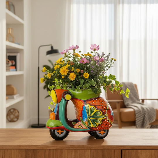 The Talavera Hub large ceramic scooter planter, hand-painted with vibrant floral designs in orange, green, blue, and yellow.
