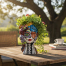 The Talavera Hub hand-painted ceramic Day of the Dead skull planter with floral motifs in red, green, blue, and yellow.