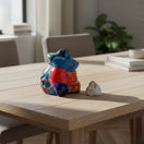 The Talavera Hub hand-painted ceramic Panchito figurine of a sleeping man, 3" tall, with vibrant blue, red, and orange Talavera patterns.