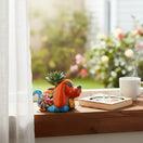 The Talavera Hub small orange dog planter with blue accents, hand-painted with floral designs. Ideal for succulents.
