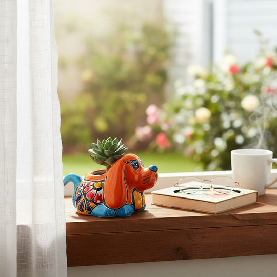 The Talavera Hub small orange dog planter with blue accents, hand-painted with floral designs. Ideal for succulents.