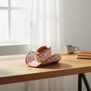 The Talavera Hub handcrafted brown and white ceramic sombrero planter with intricate hand-painted floral patterns.