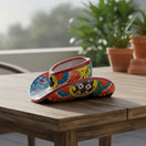 The Talavera Hub hand-painted sombrero planter in vibrant mixed colors with floral and geometric designs. Ceramic.