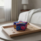 The Talavera Hub star-shaped ceramic jewelry box with vibrant hand-painted floral motifs on a wooden tray