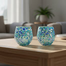 The Talavera Hub hand blown stemless wine glass with blue, green, and white confetti design. Made of recycled glass.