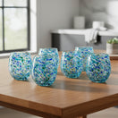 The Talavera Hub hand blown stemless wine glass with blue, green, and white confetti glass design. Made from lead-free glass.