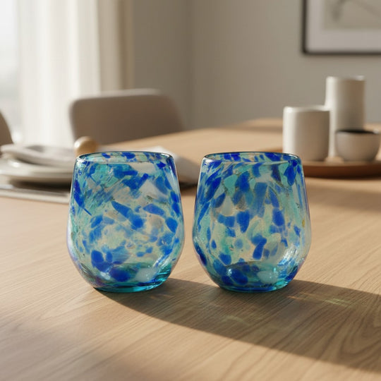 The Talavera Hub hand-blown stemless wine glass with white and blue snow design, 12 oz capacity.