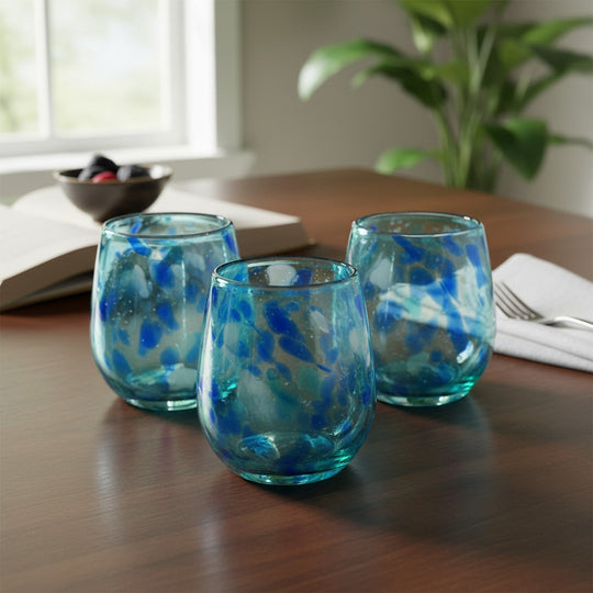 The Talavera Hub hand-blown stemless wine glass with white and blue snow design. Lead-free glass, 12 oz capacity.