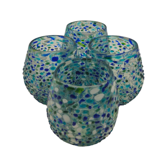The Talavera Hub hand blown stemless wine glass with blue, green, and white confetti design. Made from recycled glass.