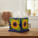 The Talavera Hub square tissue box cover featuring a hand-painted yellow sunflower design on a deep blue ceramic base.