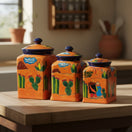 The Talavera Hub Talavera canister set with desert motifs, hand-painted ceramic in orange, blue, green, and yellow.