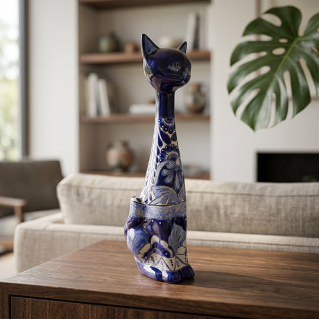 The Talavera Hub handmade tall ceramic cat statue with blue and white floral patterns on a wooden table.