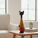 The Talavera Hub tall cat statue featuring vibrant floral terracotta patterns in blue, yellow, and orange colors.