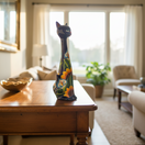 The Talavera Hub tall blue ceramic cat statue with hand-painted sunflowers and green leaves.