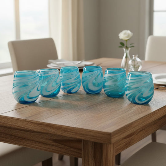 The Talavera Hub hand-blown stemless wine glasses with teal and white swirl design. Set of 6, 12 oz capacity.