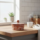 The Talavera Hub glazed terracotta tortilla warmer with hand-painted white floral Talavera motif. 6" tall, 7.5" diameter.