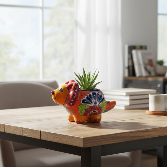 The Talavera Hub handcrafted ceramic triceratops planter with vibrant, multi-colored Mexican folk art patterns.