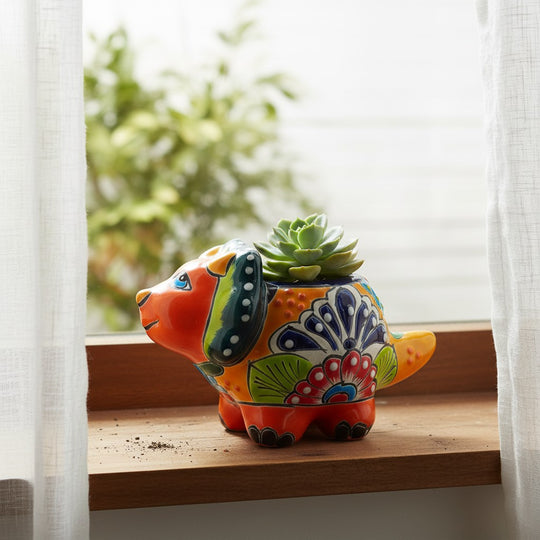 The Talavera Hub handcrafted ceramic triceratops planter with vibrant, hand-painted Mexican folk art patterns.