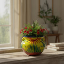 The Talavera Hub yellow ceramic cactus planter with hand-painted desert motifs and red flowers. 10" H x 12" W.