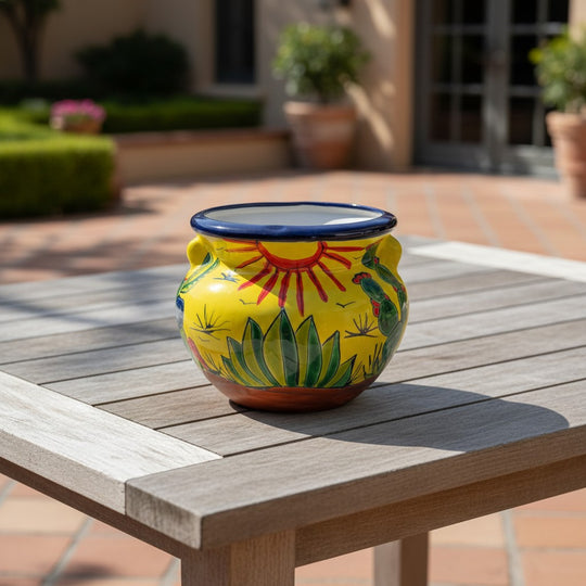 The Talavera Hub yellow ceramic cactus planter with desert motifs and handles. Handcrafted in Mexico, 10" tall.