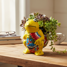 The Talavera Hub yellow ceramic frog planter with hand-painted colorful floral design on belly.