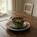The Talavera Hub 20-piece handmade ceramic dinnerware set with floral patterns, includes plates and bowls.