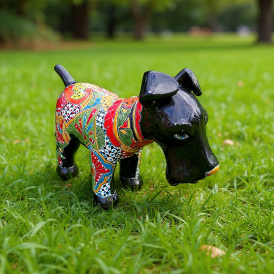The Talavera Hub black ceramic dog sculpture with vibrant hand-painted floral patterns in red, yellow, blue, and green.
