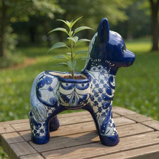 The Talavera Hub blue and white ceramic donkey planter with floral patterns. Handcrafted Mexican art.