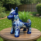 The Talavera Hub blue and white ceramic donkey planter with floral patterns. Handcrafted Mexican art.