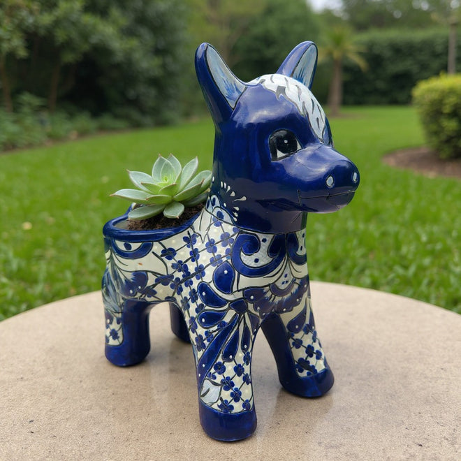The Talavera Hub blue and white ceramic donkey planter with floral patterns. Handcrafted Mexican art.