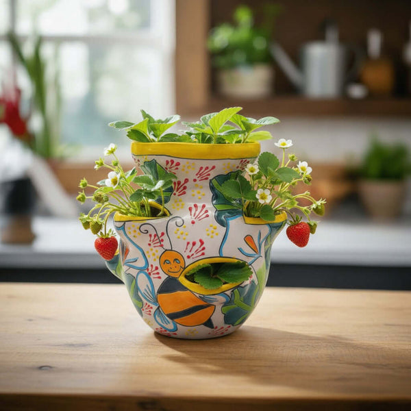 The Talavera Hub handcrafted ceramic strawberry pot with bumble bee motif and yellow rim. Ideal for herbs or flowers.