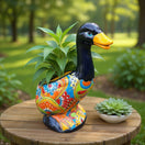 The Talavera Hub colorful hand-painted ceramic duck planter with floral designs. Features a glossy black neck and orange beak.