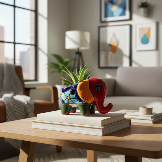 The Talavera Hub hand-painted ceramic elephant planter in red, orange, green, and blue with floral patterns. Small pot for succulents.