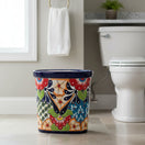 The Talavera Hub handmade ceramic oval trash can with vibrant floral and geometric Talavera designs in red, orange, blue, and green.