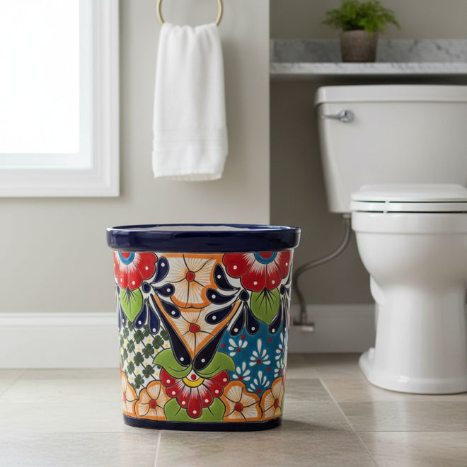 The Talavera Hub handmade ceramic oval trash can with vibrant floral and geometric Talavera designs in red, orange, blue, and green.