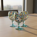 The Talavera Hub oversized fishbowl margarita glass with colorful confetti pebble design, 23 oz capacity, 8.5" tall, 6" diameter.