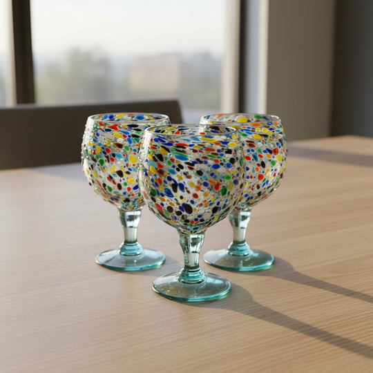 The Talavera Hub oversized fishbowl margarita glass with colorful confetti pebble design, 23 oz capacity, 8.5" tall, 6" diameter.