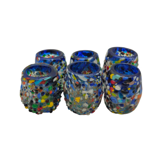 The Talavera Hub Confetti Rimmed Shot Glass with blue rim, hand-blown Mexican recycled glass with multicolor confetti.