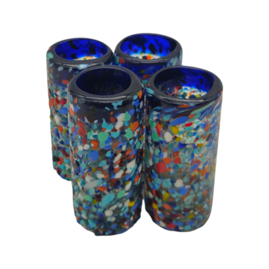 The Talavera Hub hand blown confetti shot glasses with blue rims, featuring multicolor flecks. Set of 4.