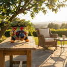 The Talavera Hub handcrafted dark blue cow planter with vibrant hand-painted floral designs and orange hooves.