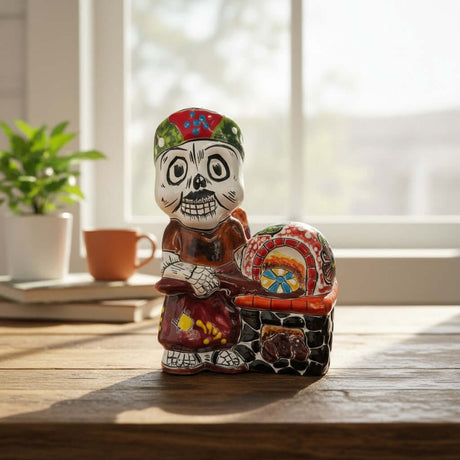 The Talavera Hub 8" Day of the Dead skeleton chef figurine in colorful attire with a hand-painted Mexican oven.